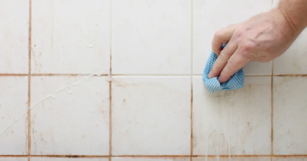 Wipe moldy tile with cloth