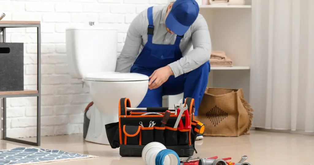 Plumber Snaking a toilet