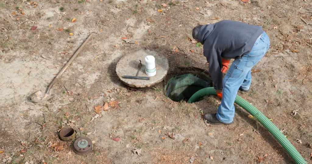 Professional emptying a flooded septic tank