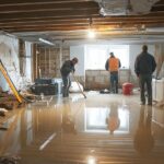 a team of professionals repair a flooded basement