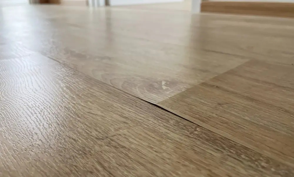 Laminate flooring beginning to bubble and rise because of water damage